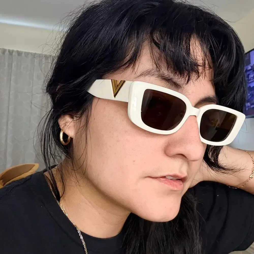 Cream sunglasses with gold accents